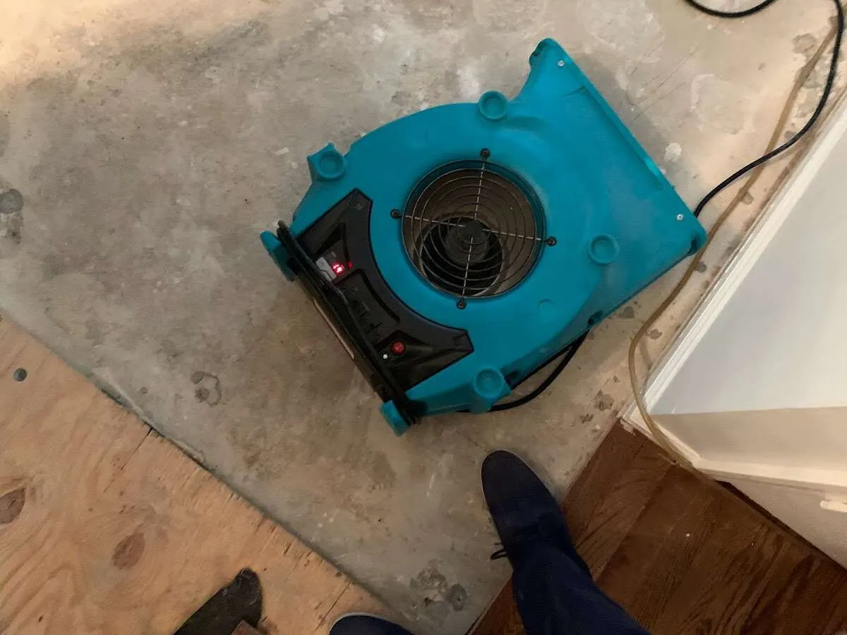 Air mover drying subfloor during Commercial Water Damage Restoration in Cazenovia